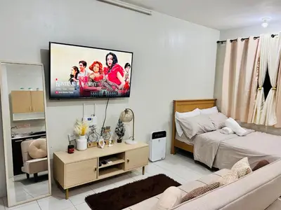 a living room with a flat screen tv on the wall at Hirayuna Space in Santa Rosa