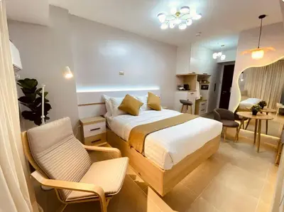 a bedroom with a bed and a living room at A Secret Space in Sucat Parañaque in Manila