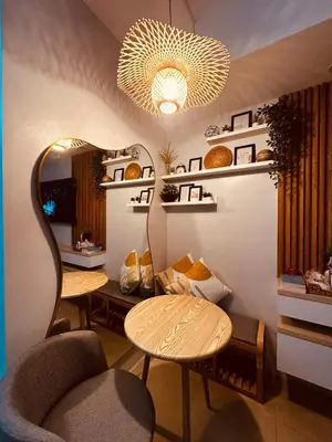 a room with two chairs and a table and a chandelier at A Secret Space in Sucat Parañaque in Manila