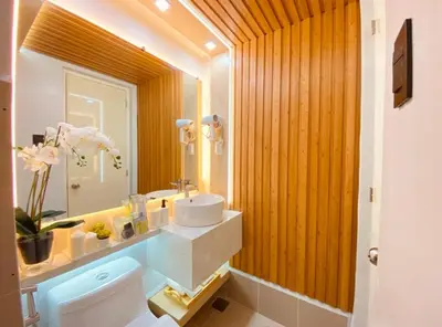 a bathroom with a sink and a toilet and a mirror at A Secret Space in Sucat Parañaque in Manila
