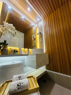 a bathroom with a toilet and a sink and a mirror at A Secret Space in Sucat Parañaque in Manila