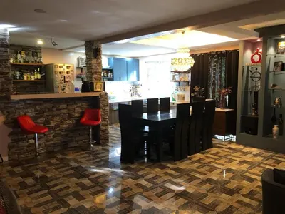 a dining room and kitchen with a table and chairs at Our home is your castle in Caong