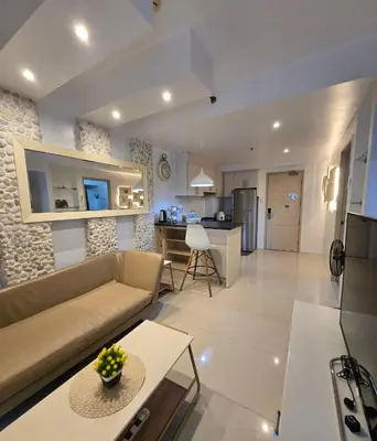 a large living room with a couch and a kitchen at Sea Residence - 2 Bedrooms - 5 mins walk to MOA 1A in Manila