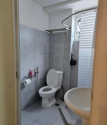 a bathroom with a toilet and a sink at Sea Residence - 2 Bedrooms - 5 mins walk to MOA 1A in Manila