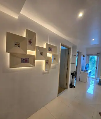 a room with white walls with shelves on the wall at Sea Residence - 2 Bedrooms - 5 mins walk to MOA 1A in Manila