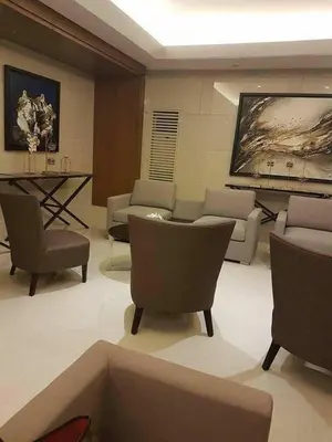 a living room with a couch and chairs and a table at Juvrey Studio-Unit Breeze Residences in Manila