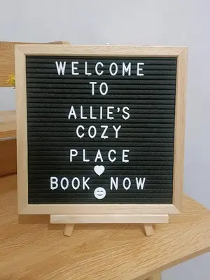 a sign that says welcome to alleerys cozy place book now at Allie's Cozy Place in Manila