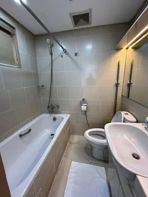 a bathroom with a tub and a toilet and a sink at Antel Spa Residences 15A in Manila