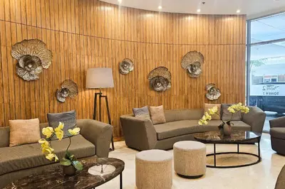 a living room with two couches and two tables at Condo in SM Mall of Asia MOA near NAIA Airport in Manila