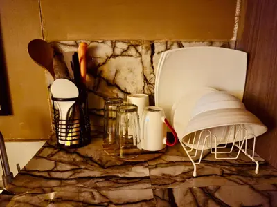 a counter with a bunch of kitchen utensils on it at PaulBert's Cabins I in Manila