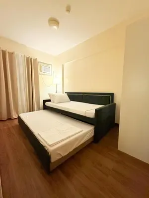 a bedroom with two beds in a room at Staycacia Haven 2BR Condo Maple Acacia Taguig in Manila