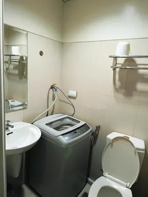 a small bathroom with a toilet and a sink at Shell Residences Mall of Asia by Jhem in Manila