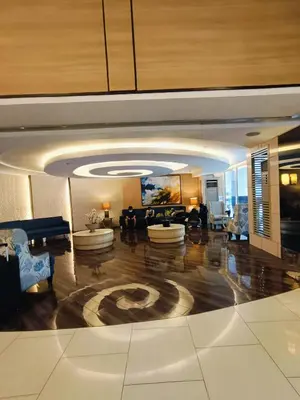 a large living room with couches and a couch at Shell Residences Mall of Asia by Jhem in Manila