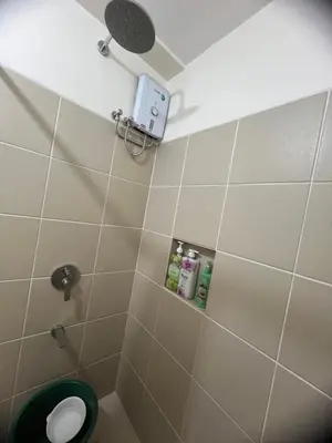 a bathroom with a toilet with a camera on the wall at Apartment 28 in Manila