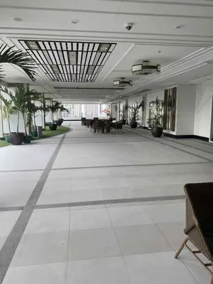 a large empty room with tables and potted plants at Apartment 28 in Manila