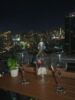 two wine glasses and a bottle on a table at Cozy and Aesthetic Vibes - Makati Manila Staycation in Manila