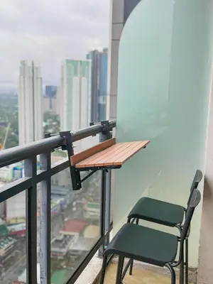 a table and chair on the balcony of a building at Cozy and Aesthetic Vibes - Makati Manila Staycation in Manila