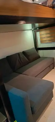 a room with two beds and a couch at Marika's Place near Airport, DFA, Mall of Asia and OWWA in Manila