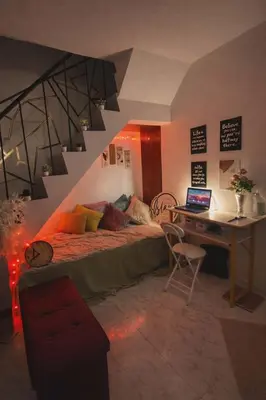 a bedroom with a bed and a desk with a laptop at Islana Stay Rm B for 1pax only in General Trias