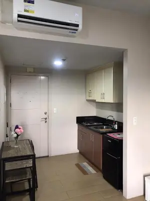 a kitchen with a sink and a stove top oven at Newport Condo near T3 - H in Manila