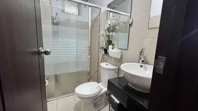 a bathroom with a toilet and a sink and a shower at 1BR Pioneer Woodland Condominium connected to BONI Metro Rail Station,Boni Mandaluyong Metro Manila in Manila