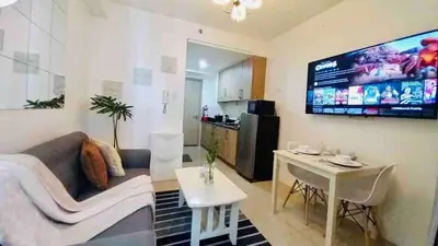 a living room with a couch and a table at Erick 1 bedroom Shore Residence 1 in Manila