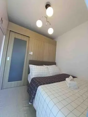 a bedroom with two beds and a window and lights at Erick 1 bedroom Shore Residence 1 in Manila