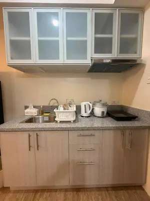 a kitchen with a sink and a counter top at Urban Oasis Cozy Studio at Berkeley Suites South Forbes Nuvali in Silang