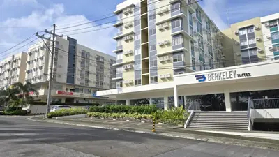 an empty parking lot in front of a building at Urban Oasis Cozy Studio at Berkeley Suites South Forbes Nuvali in Silang