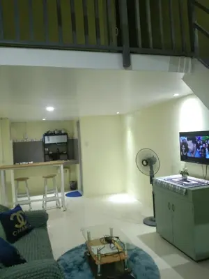 a living room with a couch and a tv at SJ Vistacation