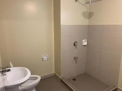 a bathroom with a toilet and a sink at Cozy Condo in Manila