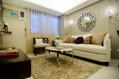a living room with a white couch and a table at Cozy Condo in Manila