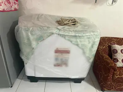 a plastic container sitting on the floor next to a couch at 1 Bedroom Townhouse with Airconditon ,Water heater and free wifi,fully furnished in San Roque