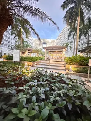 a garden of plants in front of a building at Shell Residences MOA Paul's Place in Manila