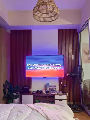 a television in a bedroom with a bed at Cityscape Staycation by H&B in Manila