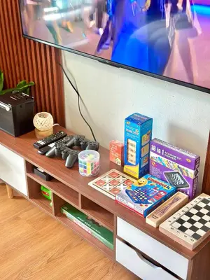 a table with a tv and games on it at Cityscape Staycation by H&B in Manila