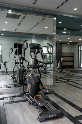 a gym with several exercise bikes in a room at Stingga McKinley Aesthetic Studio in Venice in Manila
