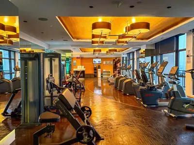 a gym with rows of treadmills and exercise bikes at Hidden Village at Gramercy Residences - APARTMENT with Infinity Pool Sauna Gym in Manila