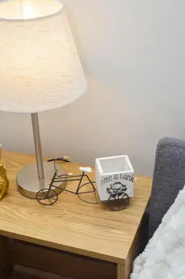 a table with a lamp and a box on it at Vue Urbain Moderne - Knightsbridge Poblacion Makati Studio in Manila