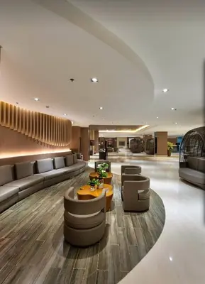 a lobby with couches and a table and chairs at Affordable Stay at Shore Residence near MOA by VCA Staycation in Manila