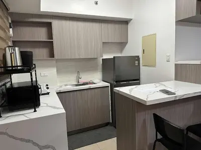 a kitchen with a sink and a counter top at Cypress Towers Staycation in Manila