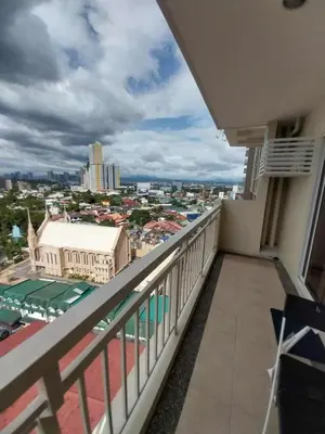 a balcony with a view of a city at Prisma Pasig Gateway with Balcony and Wifi in Manila