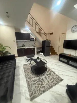 a living room with a couch and a table at Affordable makati 908 deluxe in Manila