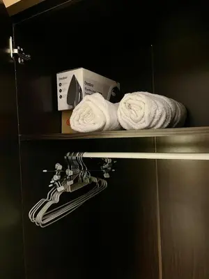 a microwave and towels on a shelf in a kitchen at Lush Urban Studio in Manila
