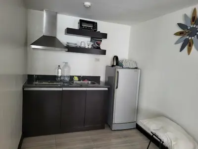 a kitchen with a refrigerator and a sink at Lancaster Hotel Manila Executive Suite Room 1001 in Manila