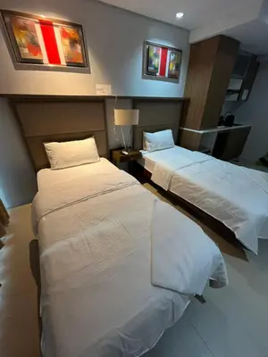 a hotel room with two beds in a room at Antel Spa Residences 1014 in Manila