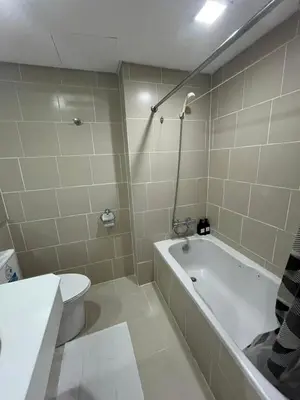 a bathroom with a bath tub and a toilet at Antel Spa Residences 1014 in Manila