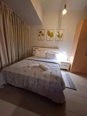a bedroom with a large bed and a window at Mysuites2go24K Parksuites T2 in Manila