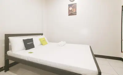 a white bed with two pillows on it in a room at UrbanView at Mherylle's Apartment near UST Manila in Manila