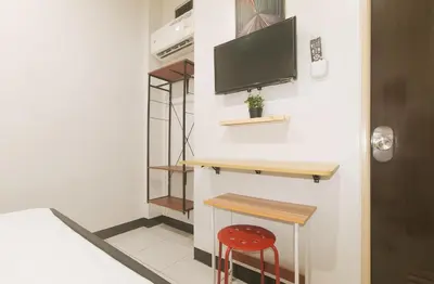a small room with a desk and a red stool at UrbanView at Mherylle's Apartment near UST Manila in Manila